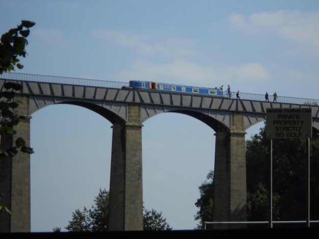 Narrowboat cossing the Aqueduct as seen from below