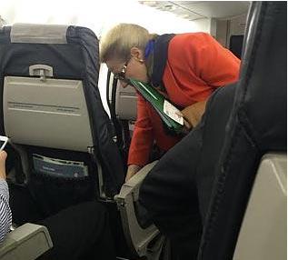 Bronwyn Bishop in economy. Is she wiping the seat? Photo: SMH